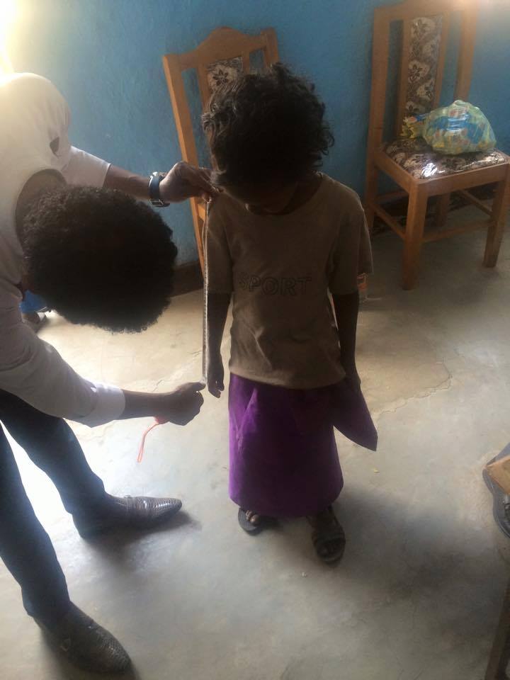 Orphans supported by Miss Africa USA get measurements for New School Uniforms.